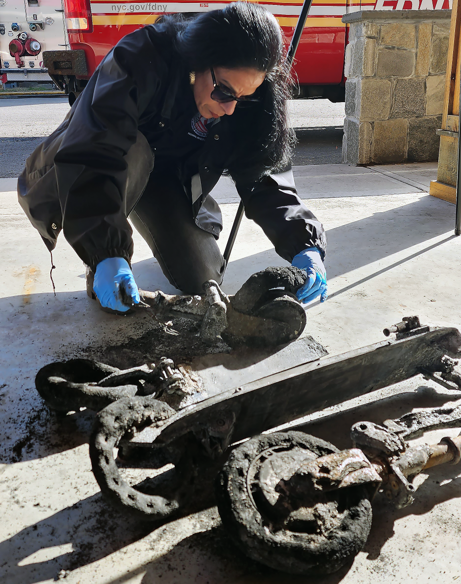 A CPSC field investigator inspects an e-scooter during an event at the FDNY Fire Academy on Randalls Island, NY. The scooter’s lithium-ion battery caused a fire in the city.