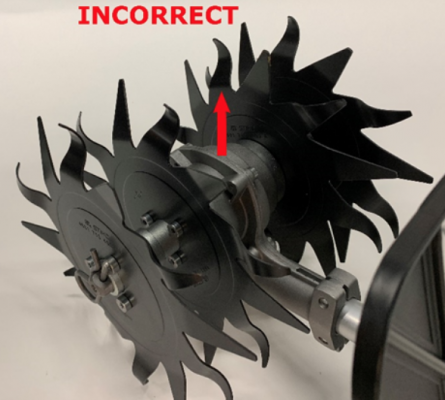 Recalled mini-cultivator attachment.  Close-up of gearbox mounted upside down so that the axle is above the drive tube.