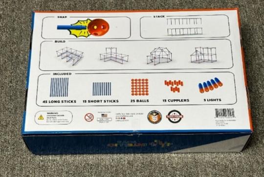 The recalled Intellio Toys’ Bright Builder fort kit has 100 pieces and a pack of five flashlights with button cell batteries. A photo of the flashlights appears on the back of the recalled Bright Builder fort kits.