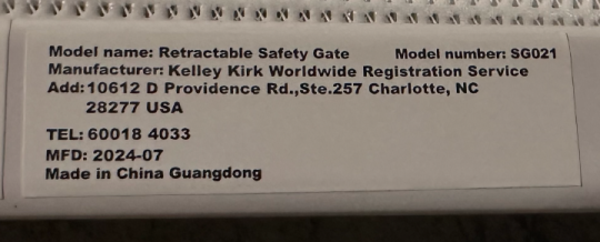 “Retractable Safety Gate” and “Model number: SG021” are printed on a white label located on the inside of the gate’s frame.