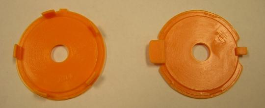 The recalled throat plate (left) and the new, replacement throat plate (right)