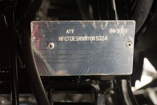 The adult ATV’s model number appears on a plate located next to the vehicle’s front right tire