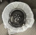 Example of photo with straps cut off and recalled helmet inside a trash can, rendering helmet unusable