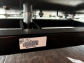 Location of model name and the serial number on the connecting bar at the bottom of the treadmill